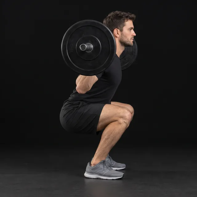 A person doing barbell back squats