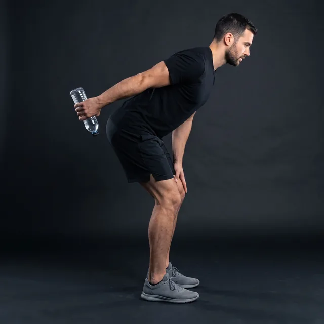 A person doing bottle triceps kickbacks