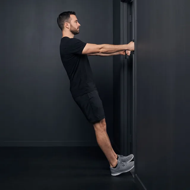A person doing doorframe rows