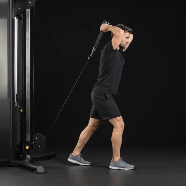 A person doing overhead cable triceps extension