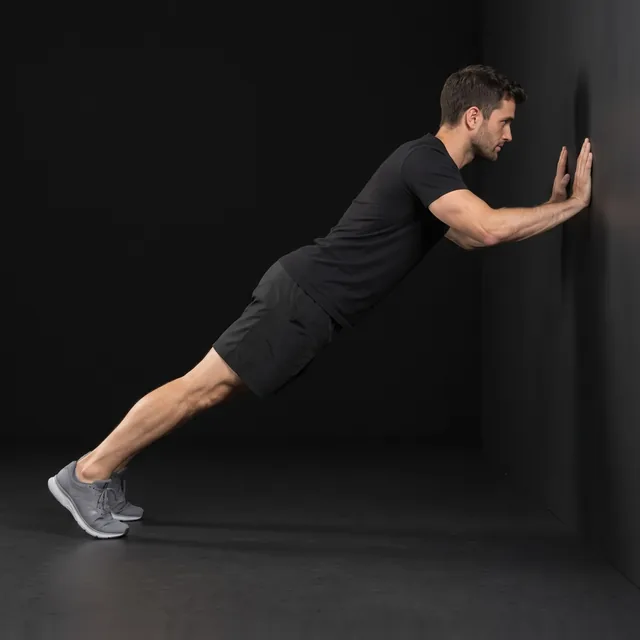 A person doing wall push-ups